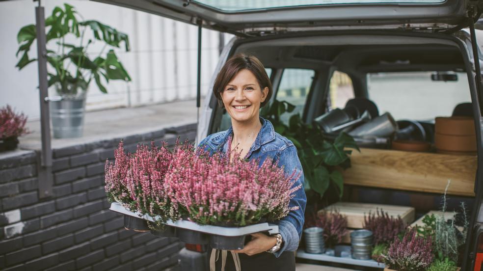 Woman with flowers by car
